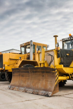 Two heavy wheeled tractor one excavator and other construction machinery Two heavy wheeled tractor one excavator and other construction machinery